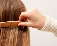 close-up-hand-brushing-hair_23-2149149952